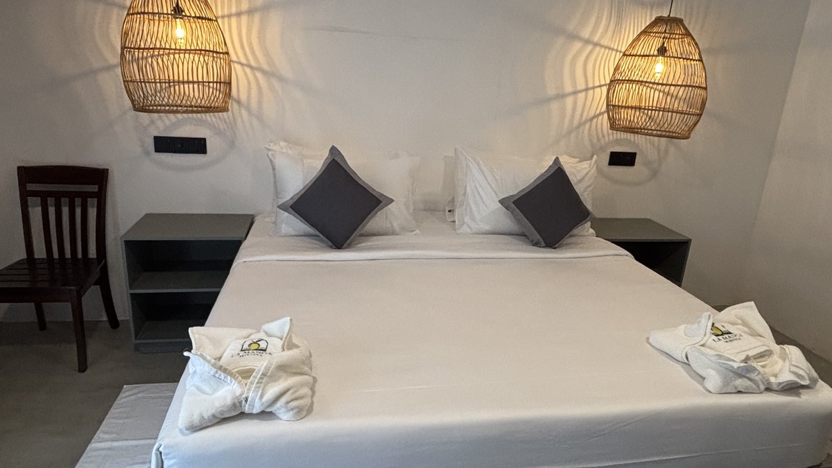 Garden deluxe double room at LÁ MANGÁ with twin rattan pendant lights and garden view